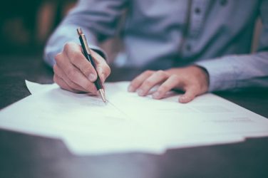 Image of a Man Signing a Will. Hendrickson & Long, PLLC’s Attorneys Are Ready to Represent the Rights of Those Involved in a Will Contest in WV, KY, or PA.